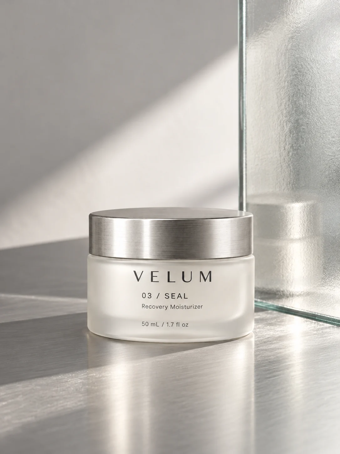 VELUM SEAL beside textured glass, with sunlight and precise architectural shadows